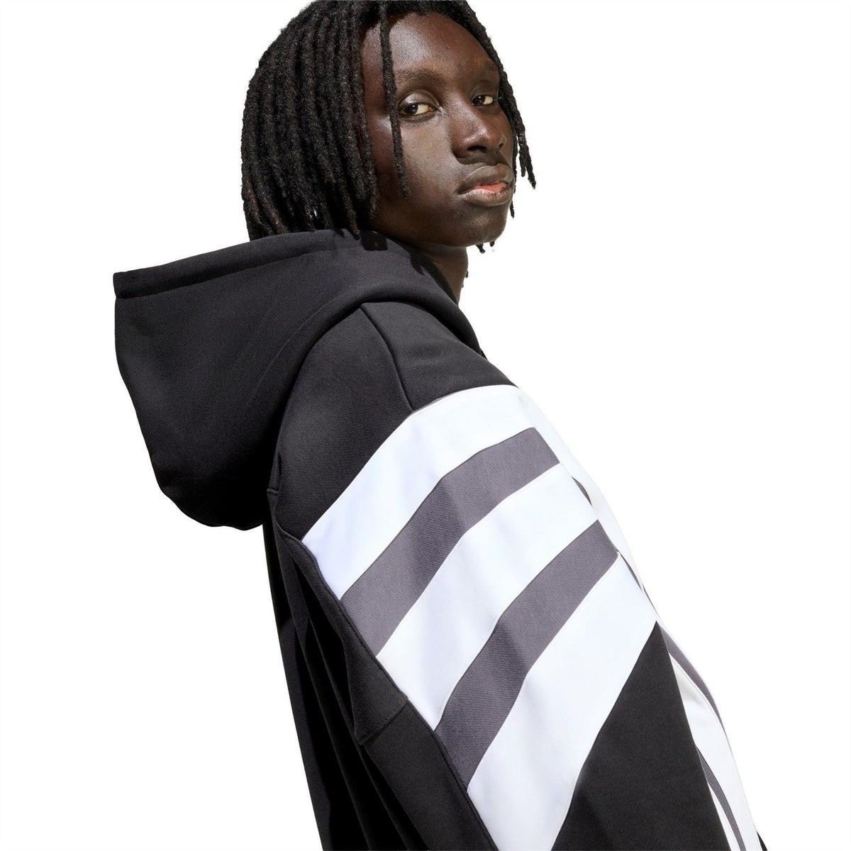 Black hoodie close-up with grey yoke, white striped sleeve, and drawstring hood