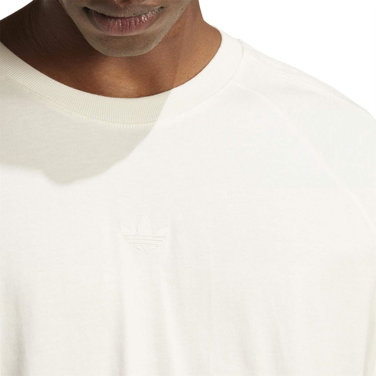 Cloud white crew-neck T-shirt close-up with rib collar and small chest logo