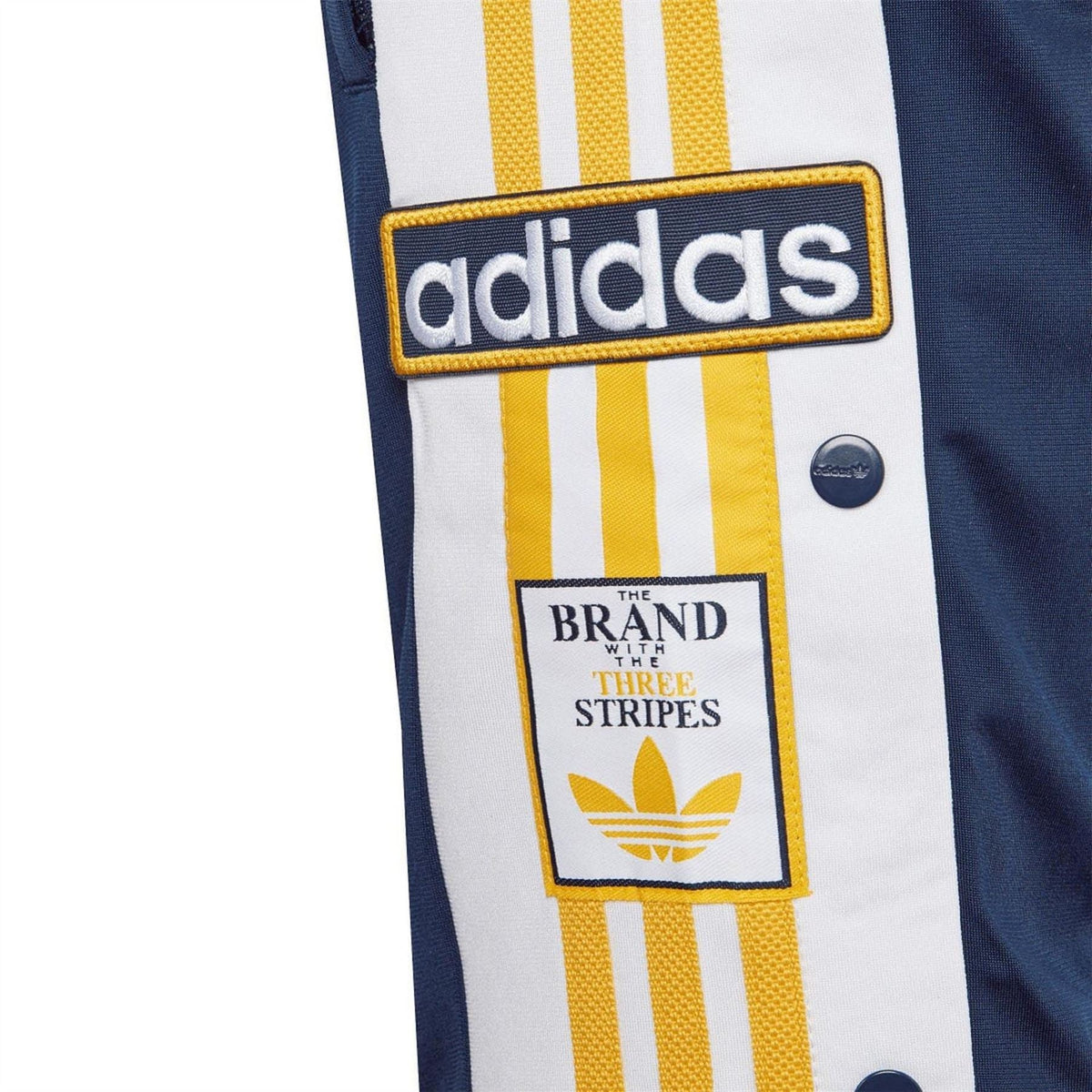 adidas Originals shorts leg logo patch on white and yellow striped panel