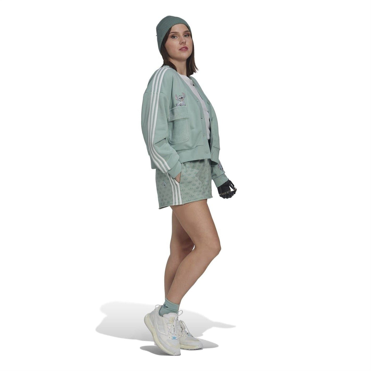 Mint green shorts hem with adidas logo and Disney graphic; allover leaf and character print