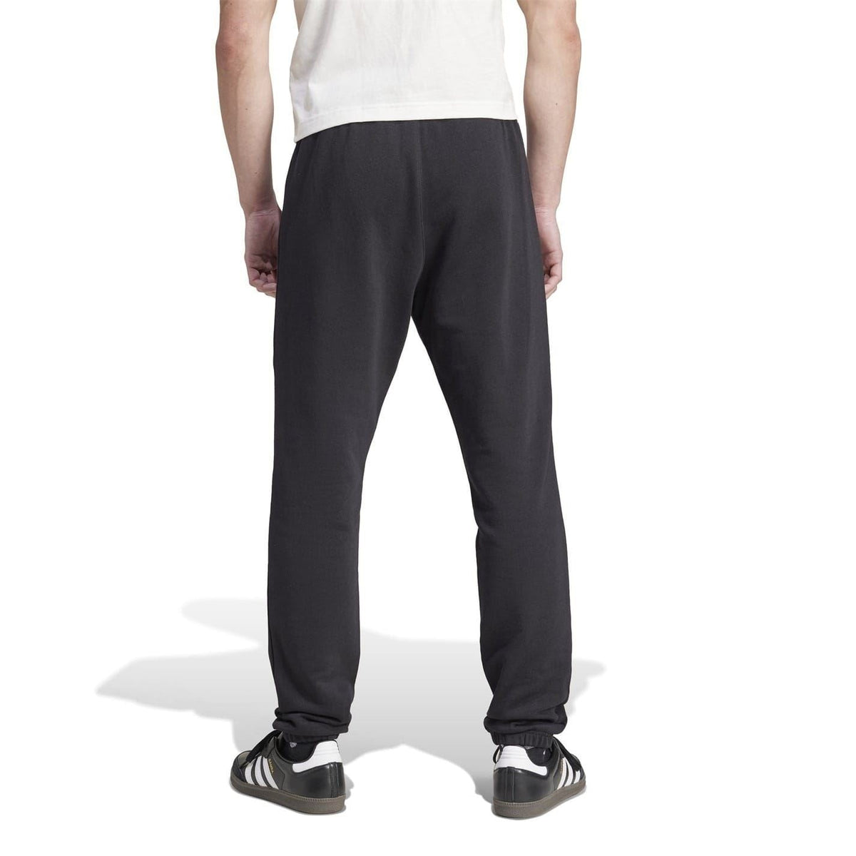 Black tapered joggers with elastic ankle cuffs and adidas logo detail on thigh