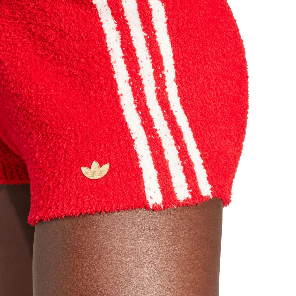 Red knit shorts detail: white triple stripe and adidas trefoil badge