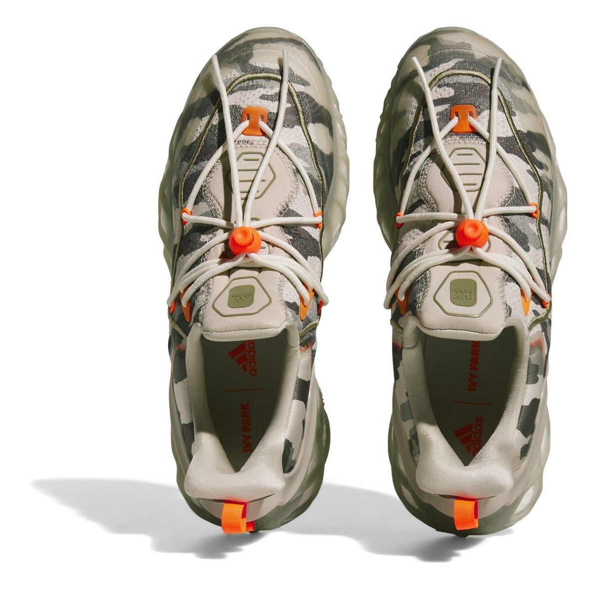 Front view of camo chunky trainers with white laces and orange pull tabs