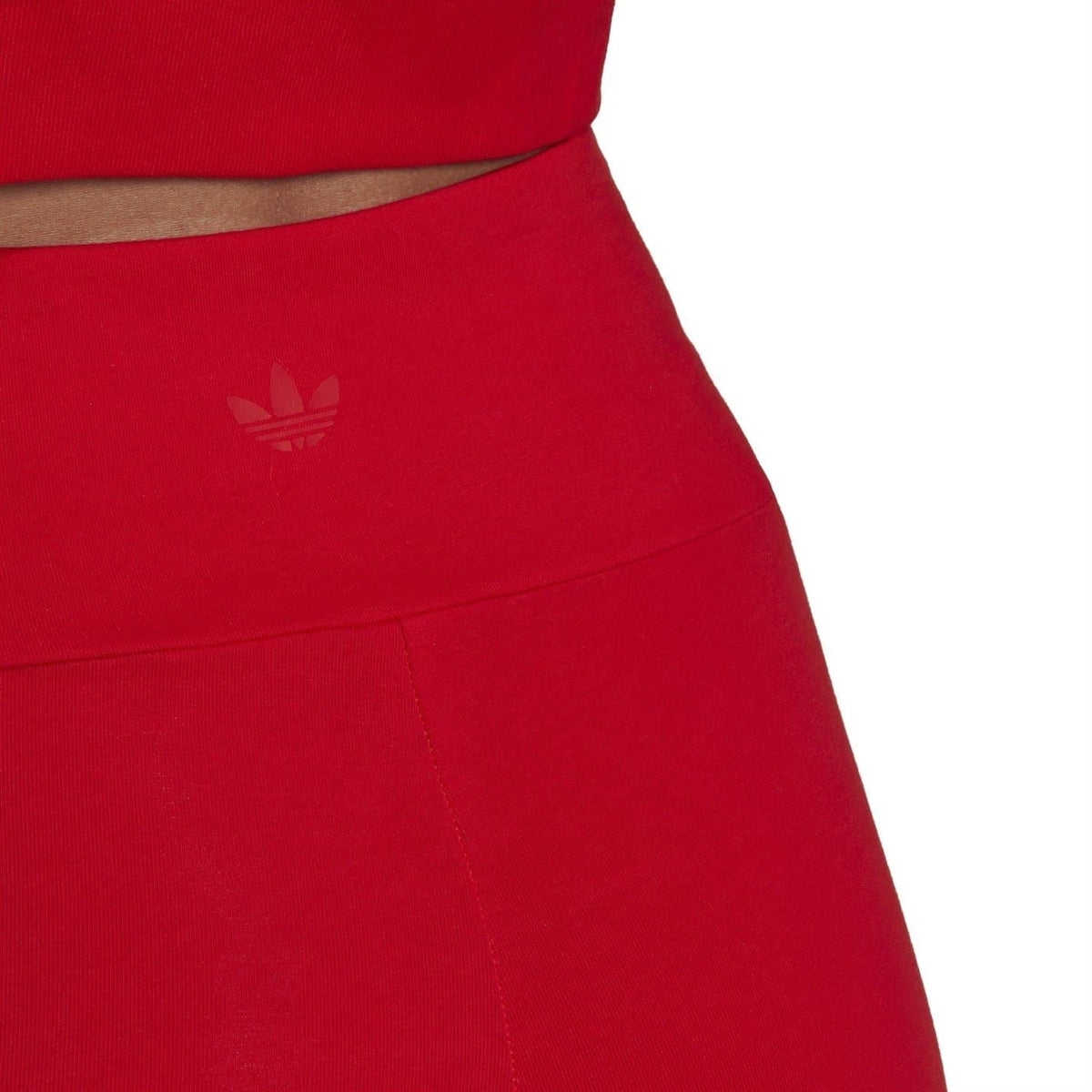 Red slim-fit bike shorts with small adidas trefoil logo at thigh