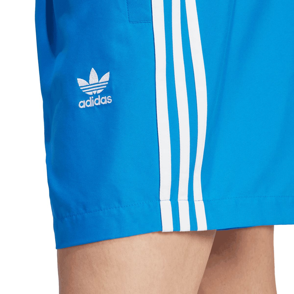Blue adidas swim shorts with adidas logo patch and three white side stripes