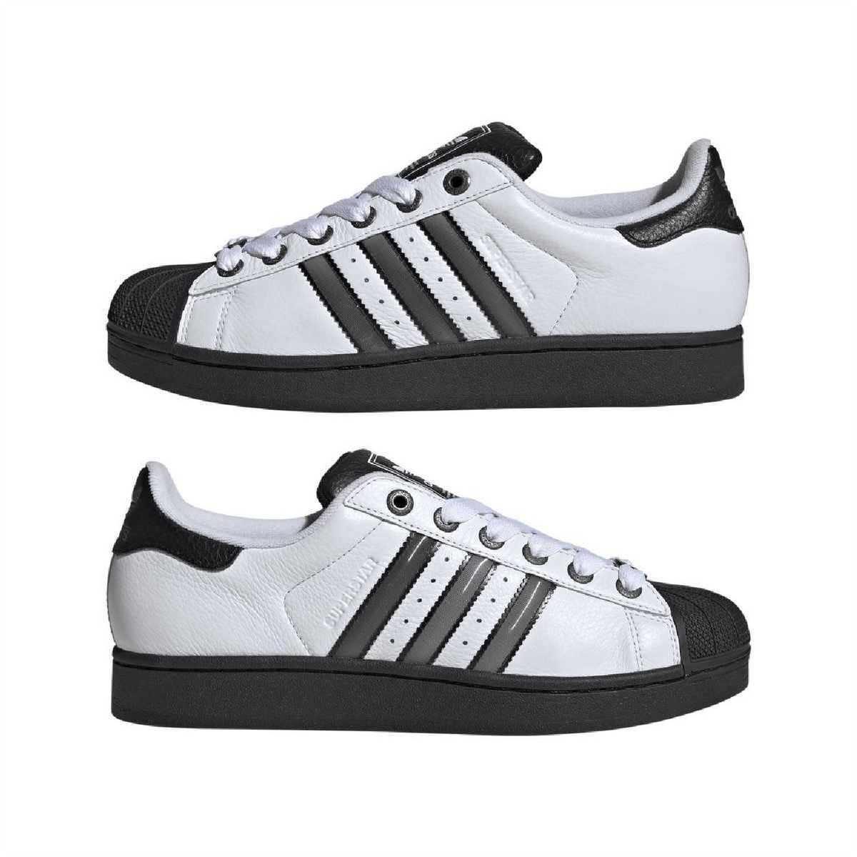 Pair of white leather low-top sneakers with black heel patch and three stripes