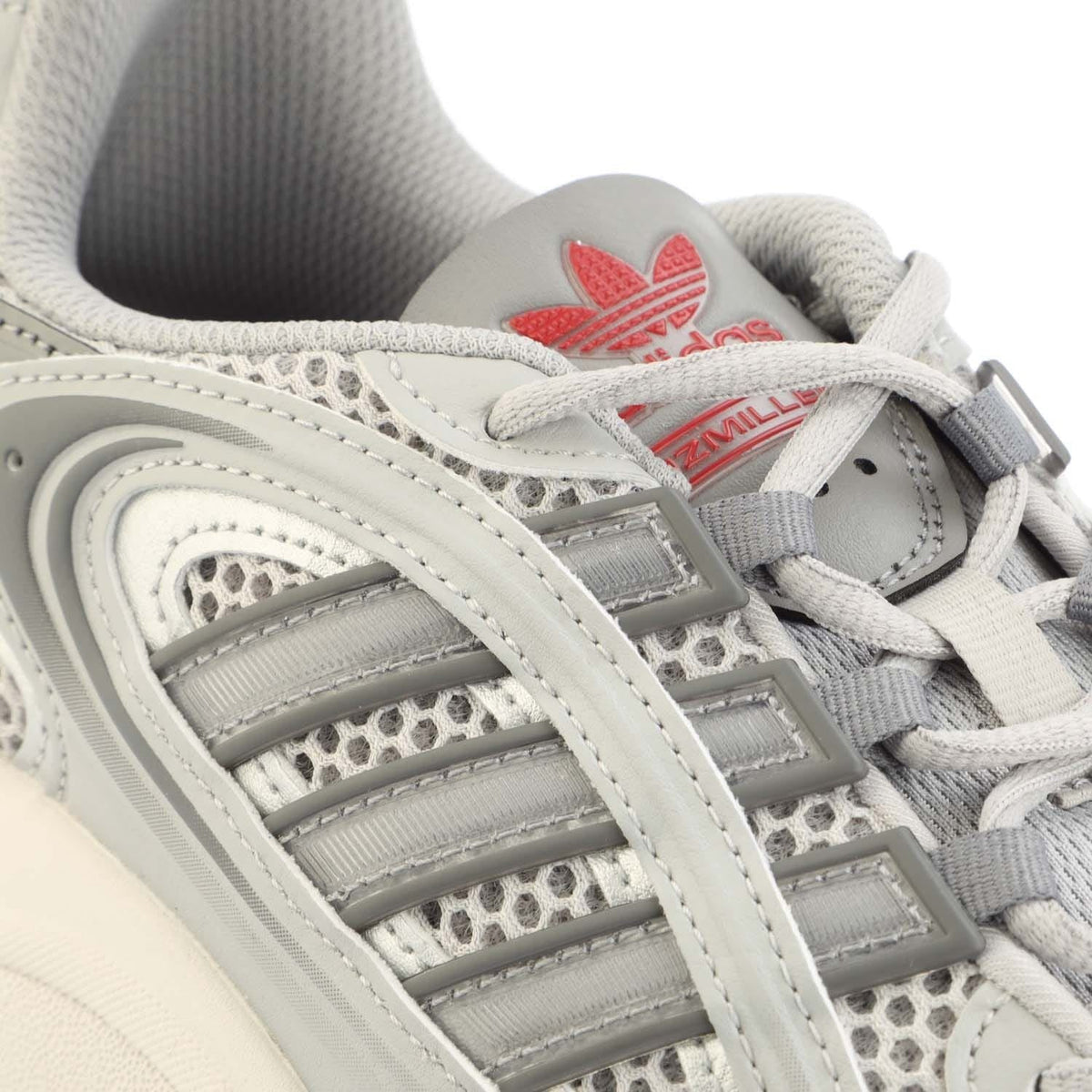 Close-up of grey Adidas Originals Ozmillen lace-up with metallic straps and mesh