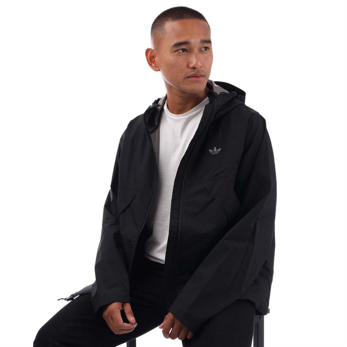 Black hooded shell jacket with adidas trefoil on chest and front zip closure.