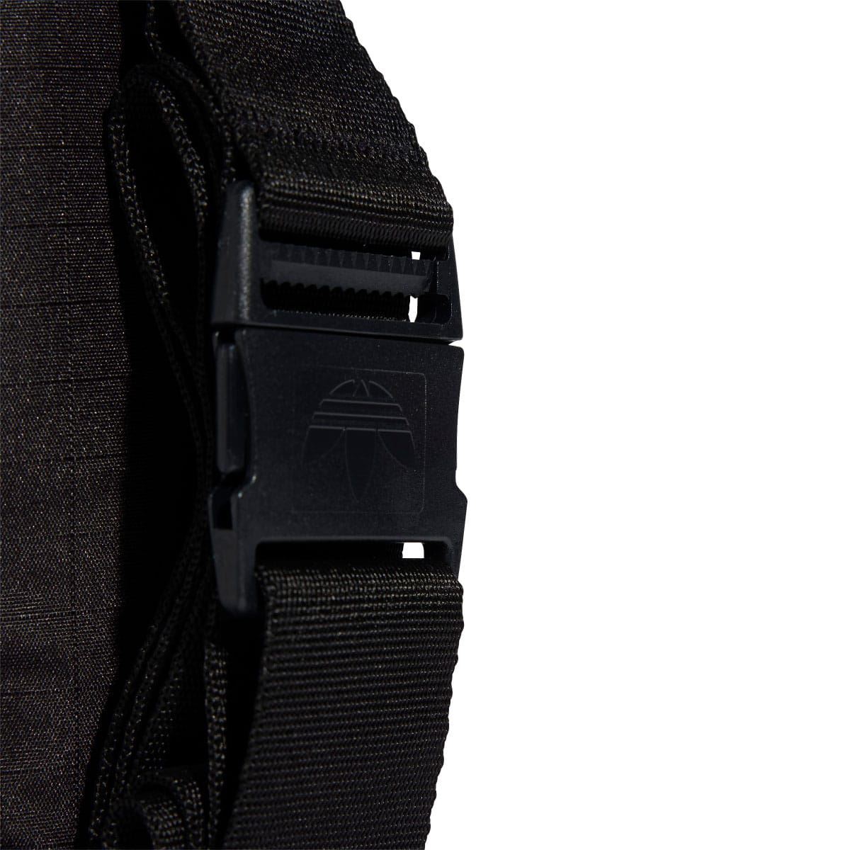 Black adidas small item bag strap hardware and webbing close-up.