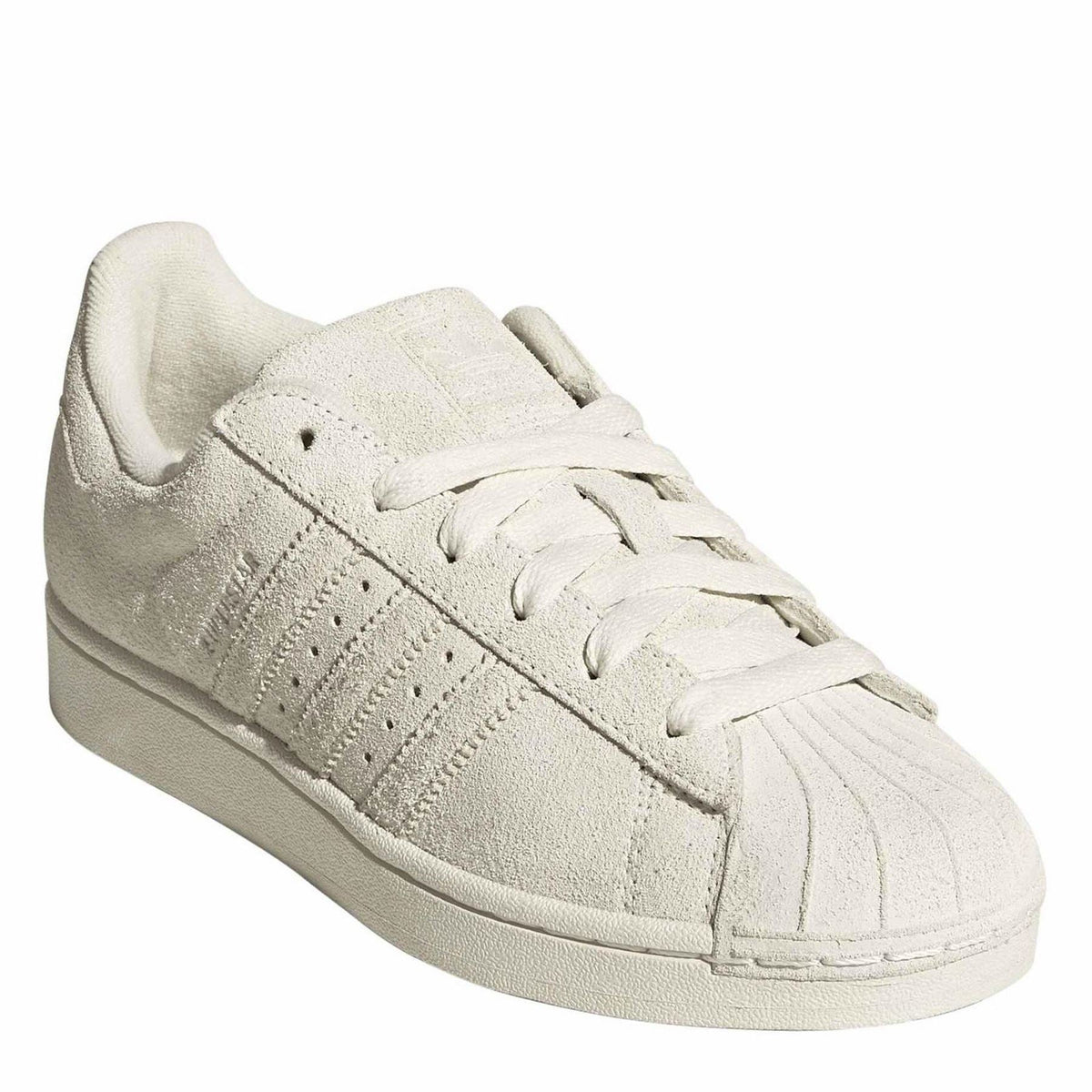 Light cream suede low-top sneakers with lace-up front and rounded toe shell