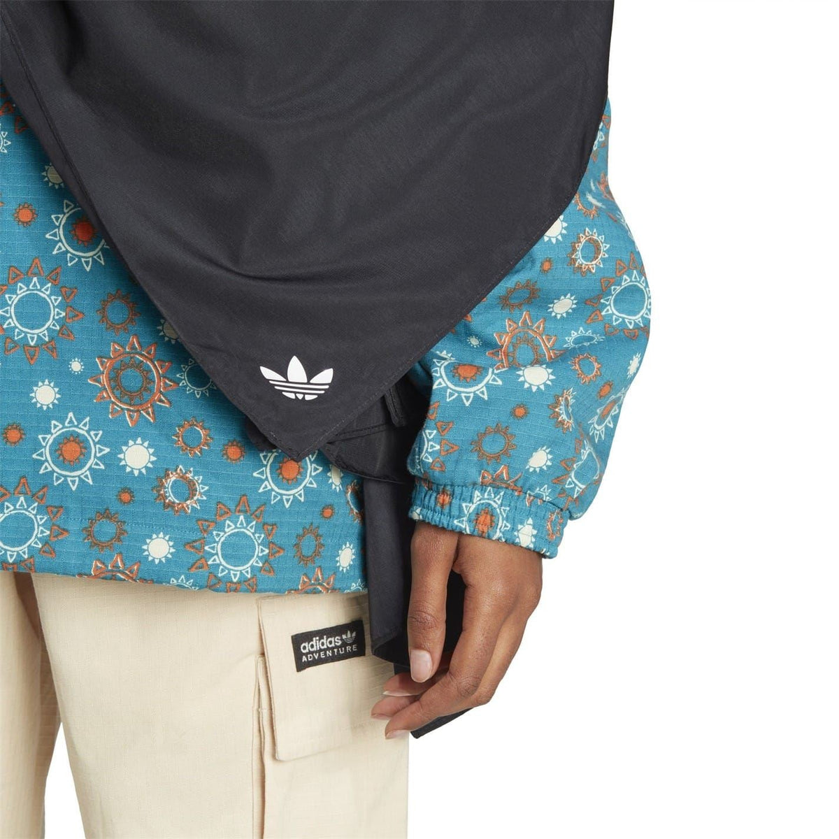 Black head scarf worn at the neck with adidas logo near the bottom edge