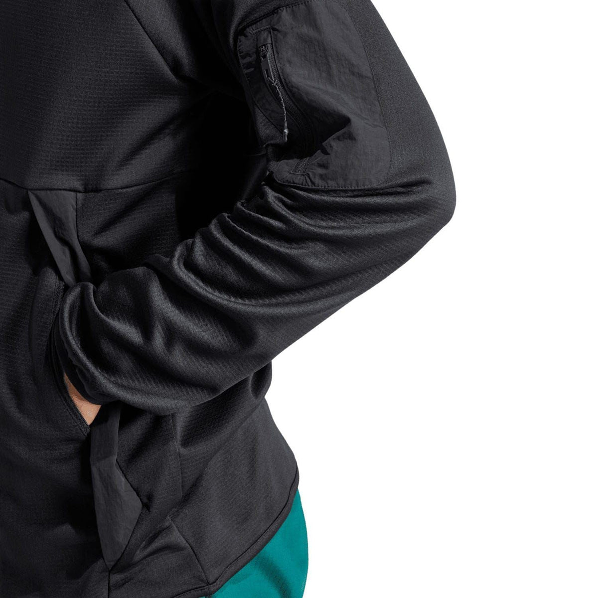 Black adidas quarter-zip top sleeve and side pocket detail