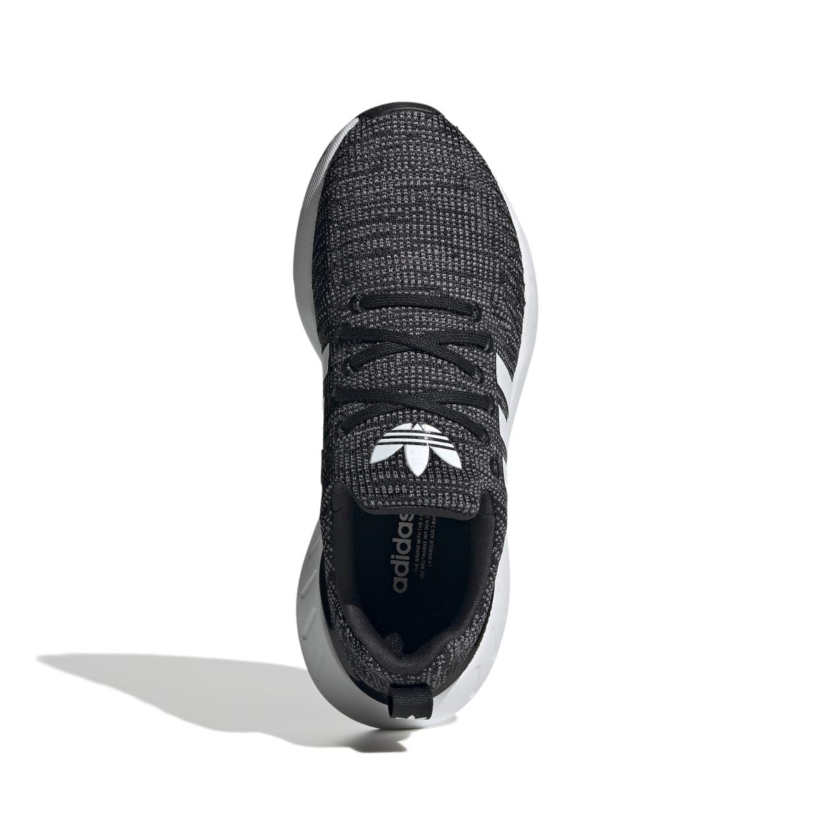Junior adidas Swift Run 22 trainers toe view, black knit upper with lace-up and white stripes.