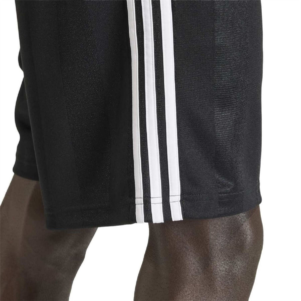 Black shorts hem close-up with white triple stripe panel along the side