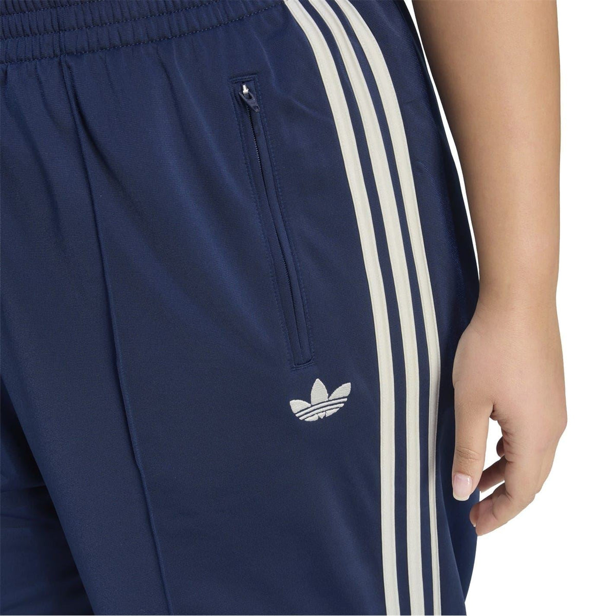 Dark navy track pants with white side stripes, front zip pocket, and small Adidas logo
