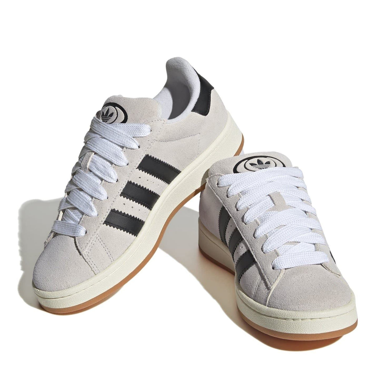 adidas Campus trainers with white laces, light grey suede, and black stripes