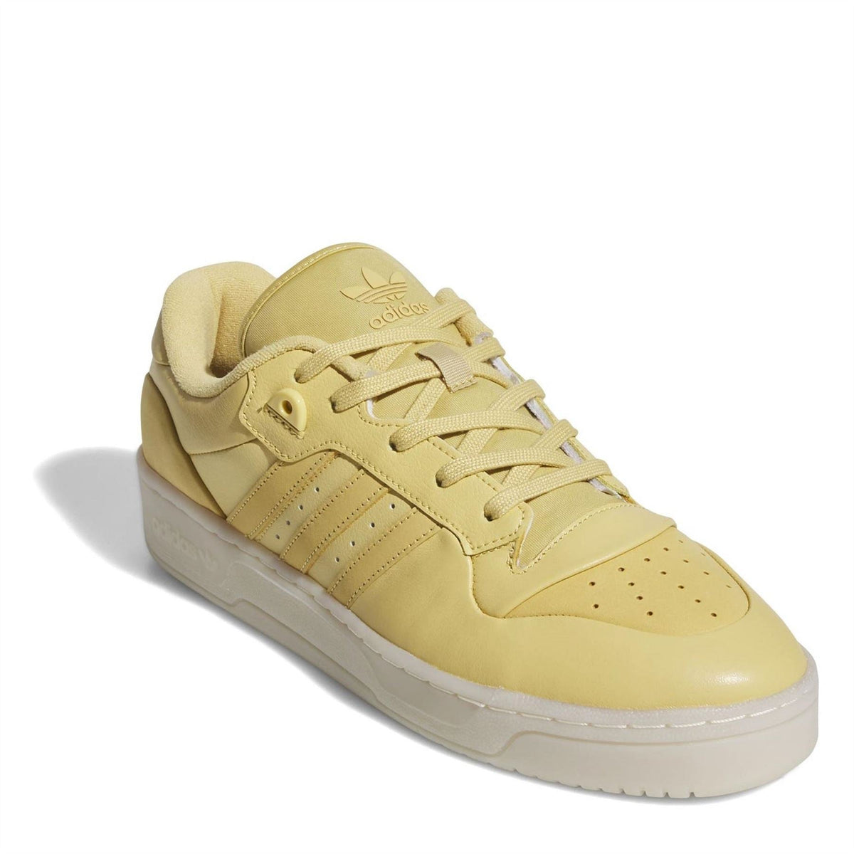 adidas Rivalry low-top flatform sneaker, angled front view in yellow with stripes