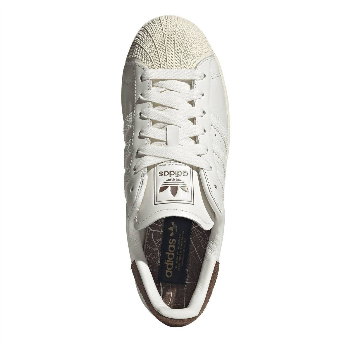 White adidas Superstar II sneaker with logo sockliner and lace-up upper shown toe-up.