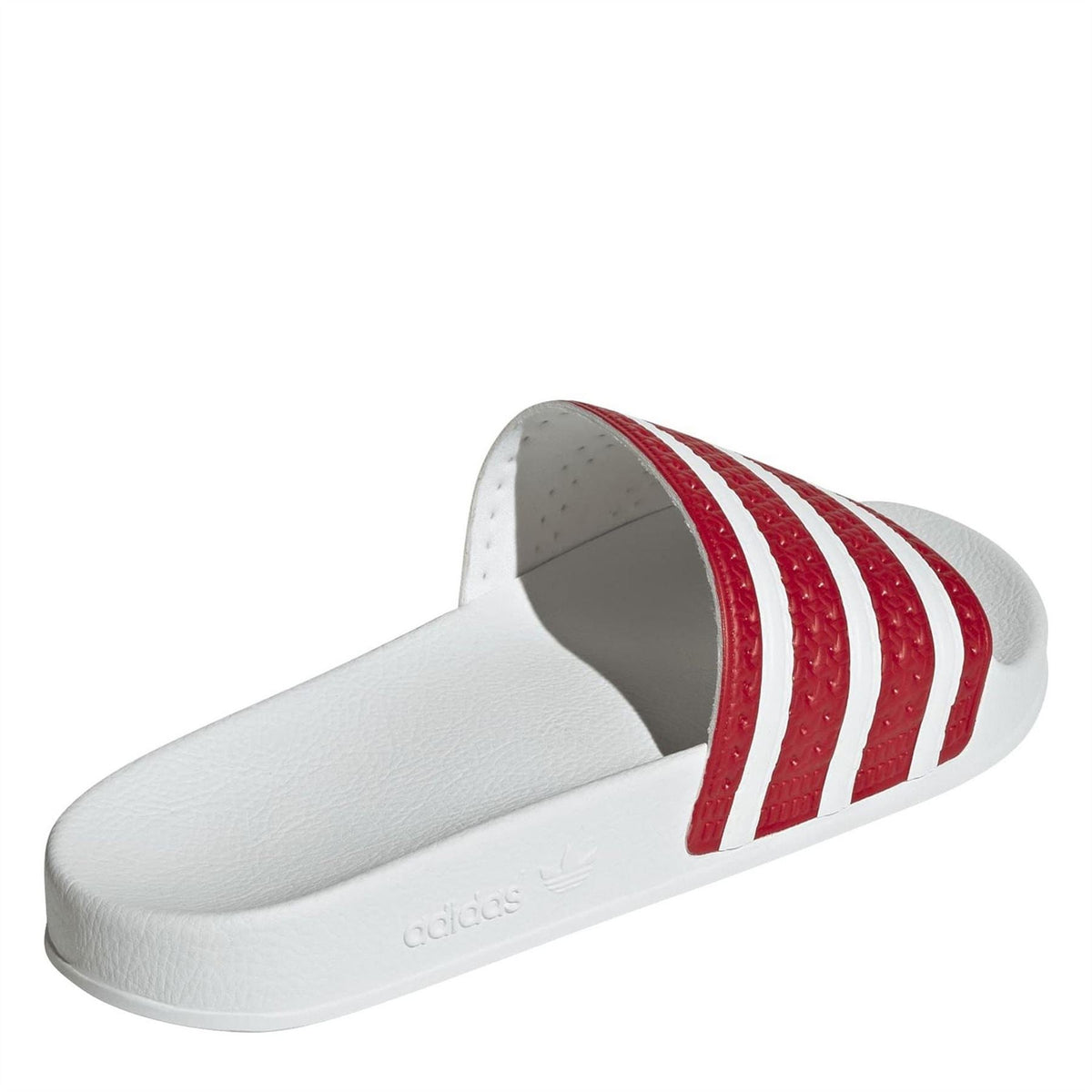 Red and white adidas Originals slide sandals, side view of cushioned white footbed