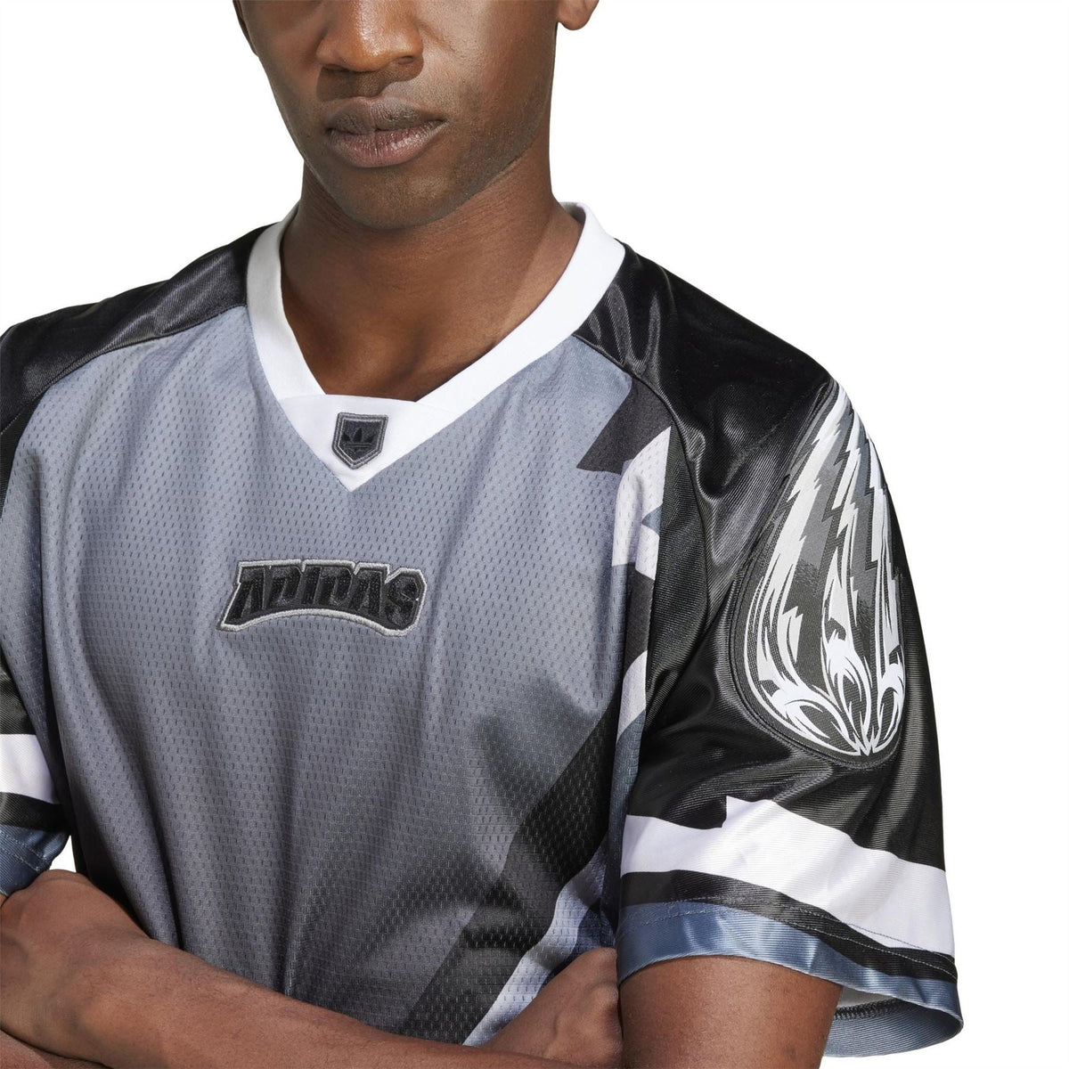 Close-up of black and gray team jersey with adidas logo patch and lightning pattern