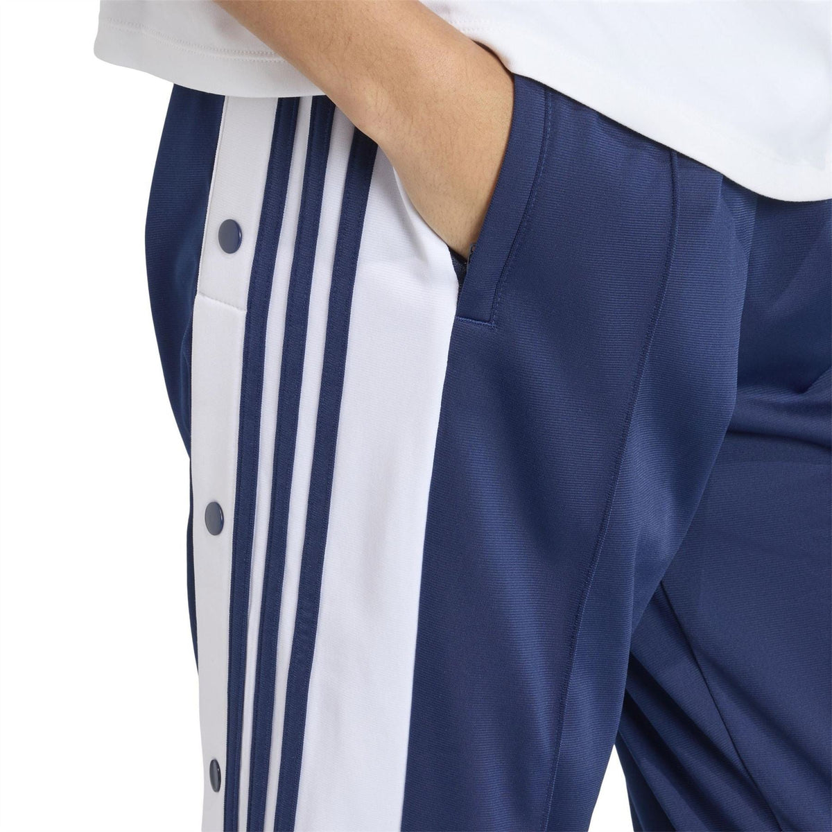 close-up of adidas Originals track pants: dark blue fabric with white vertical side stripes