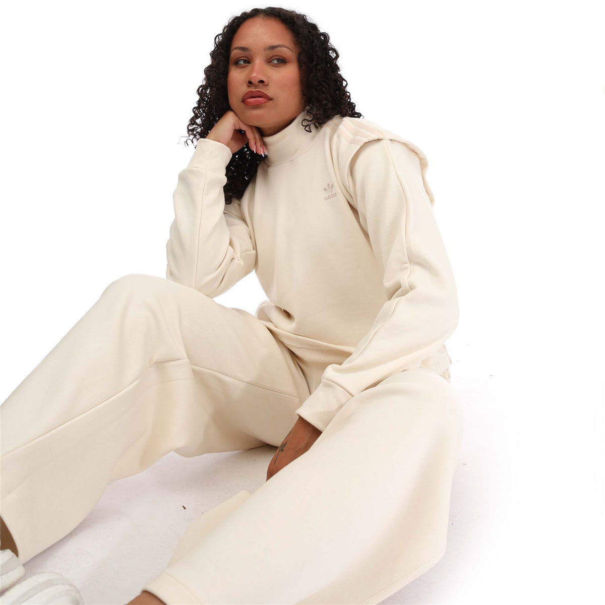 Cream adidas sweatshirt with long sleeves, ribbed cuffs, and crewneck collar