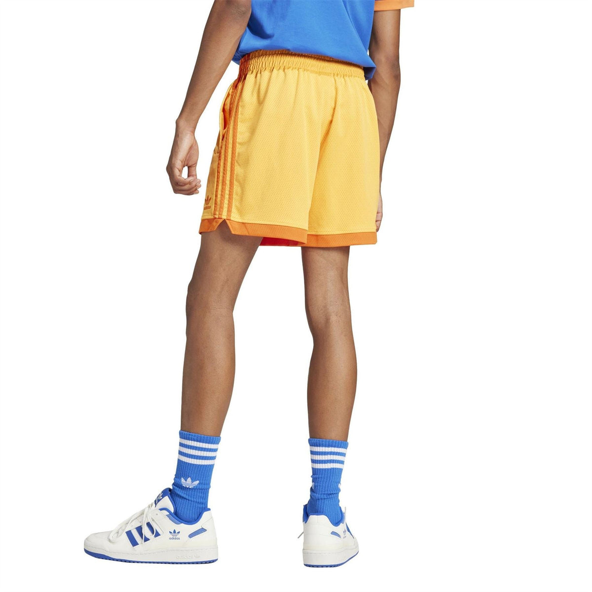 Yellow adidas Originals shorts with elastic waistband and orange side stripe detail