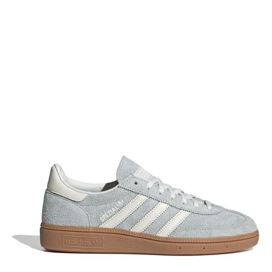 Light gray suede low-top sneakers with white three stripes and gum rubber sole