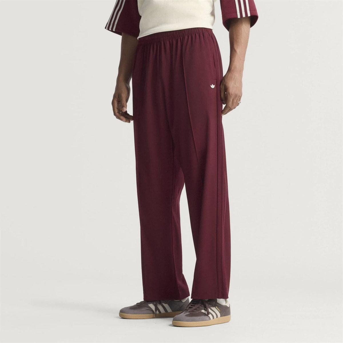 Maroon adidas Originals baggy track pants with elastic waist and relaxed leg opening