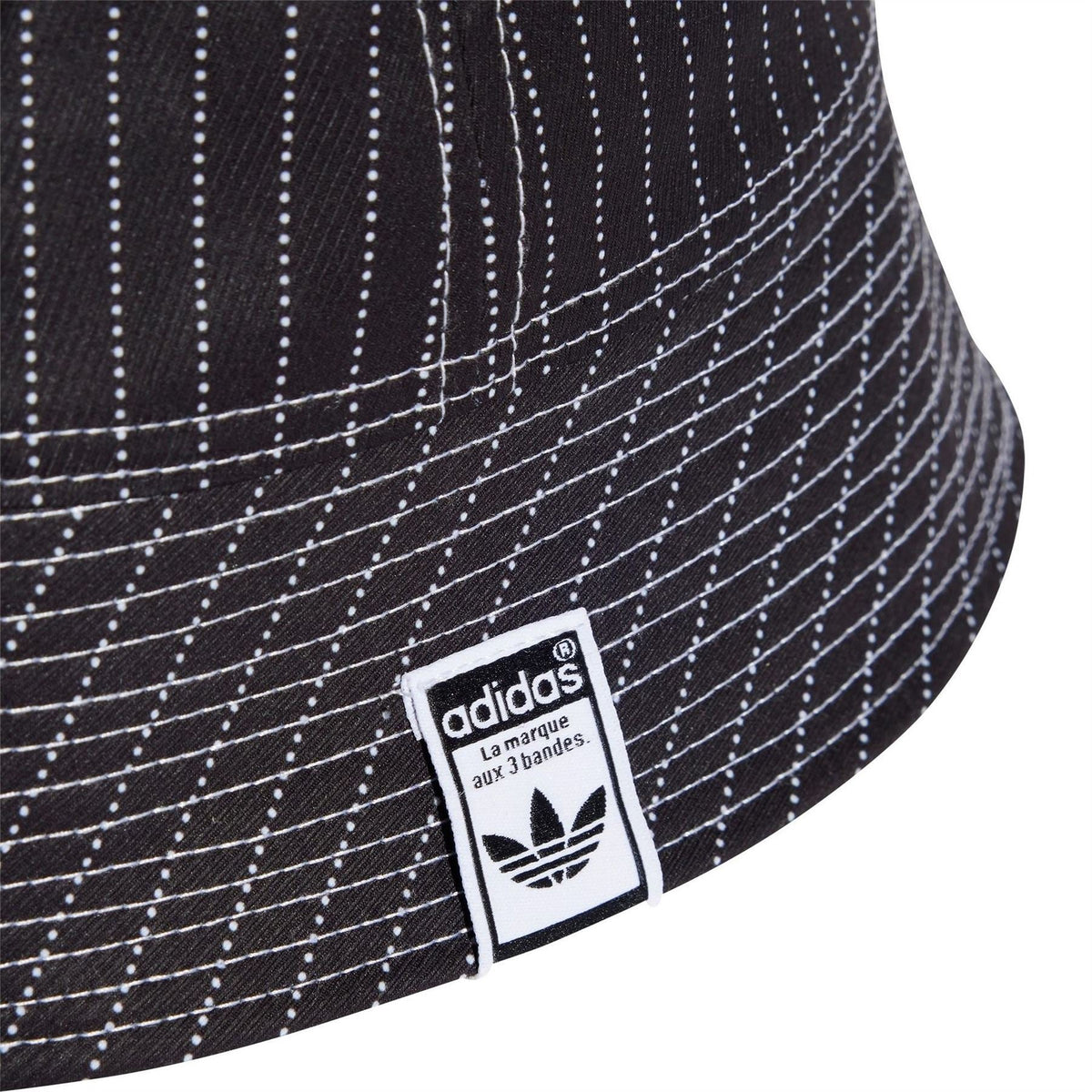 Black bucket hat with white dotted stripes and adidas label on side panel