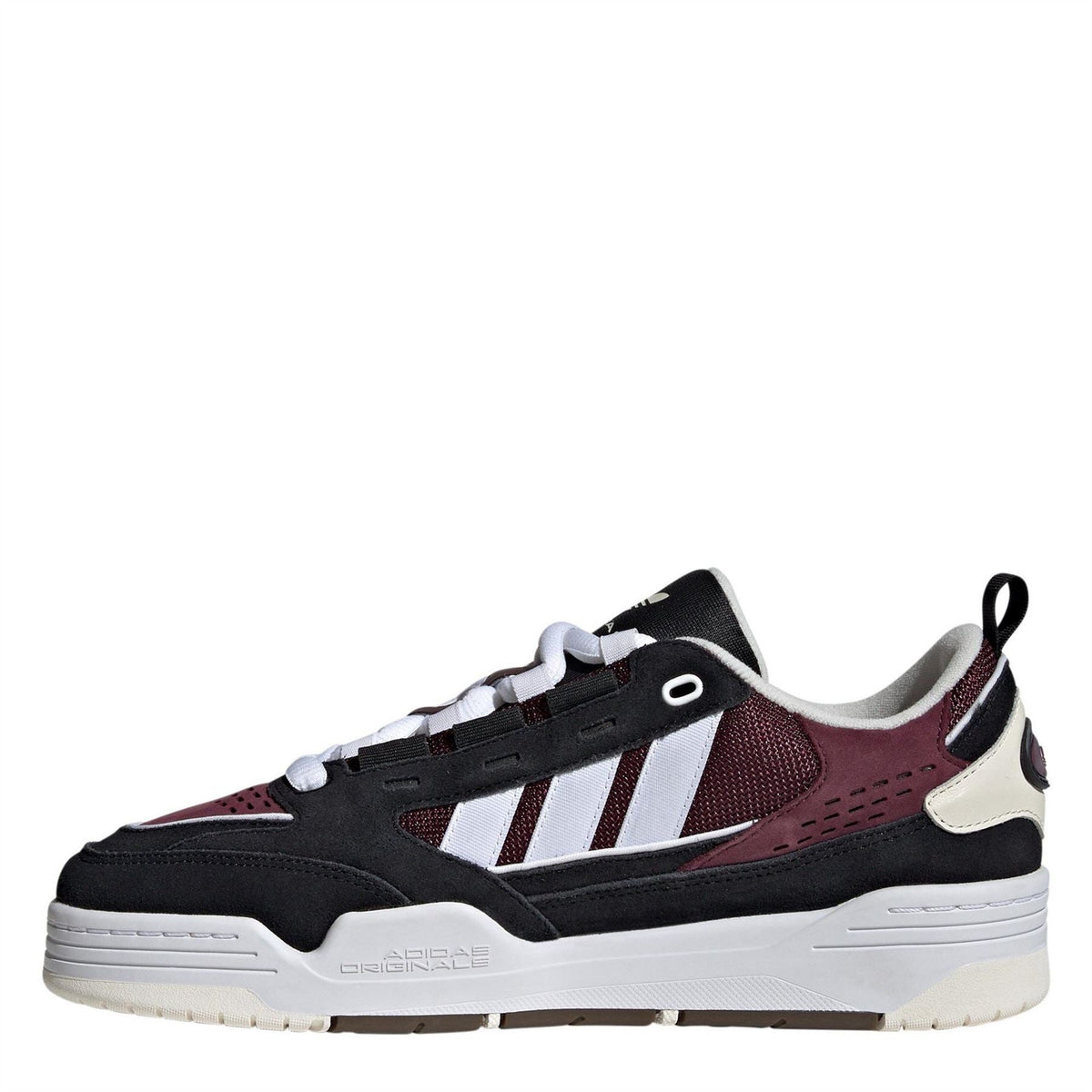 Kids' low-top trainers, side view, black with burgundy panels and white stripes