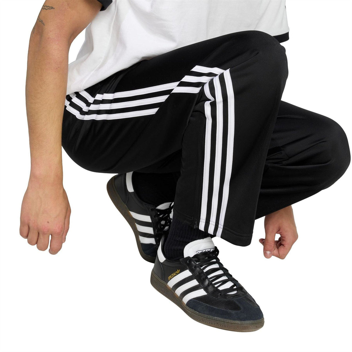 adidas men's black woven track joggers with stacked white side stripes and open hem