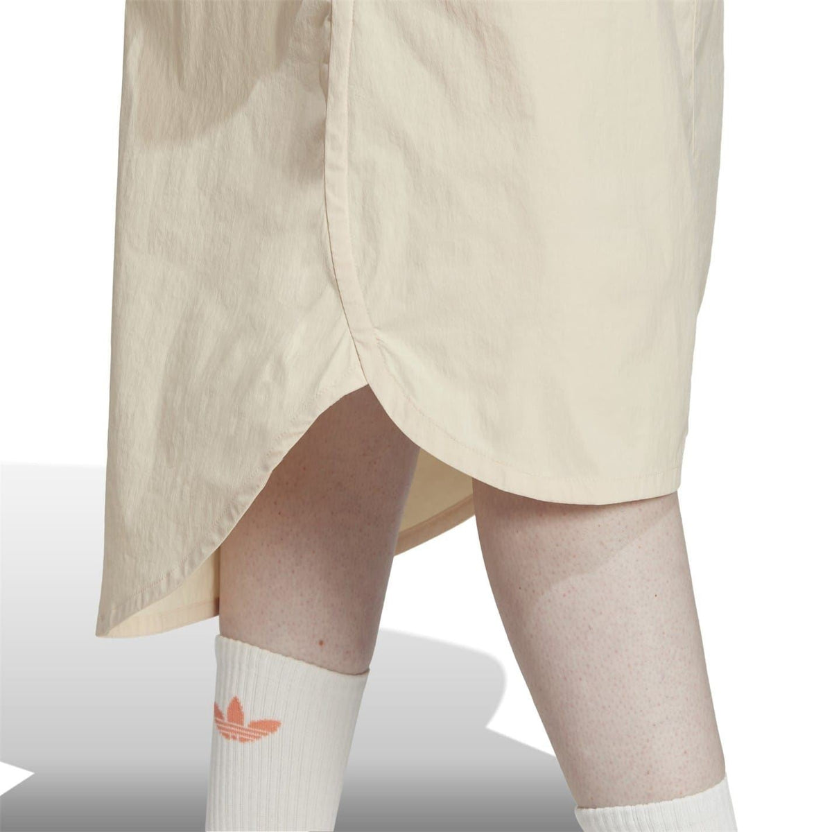 Light beige adidas Originals midi shorts with curved high-low hem