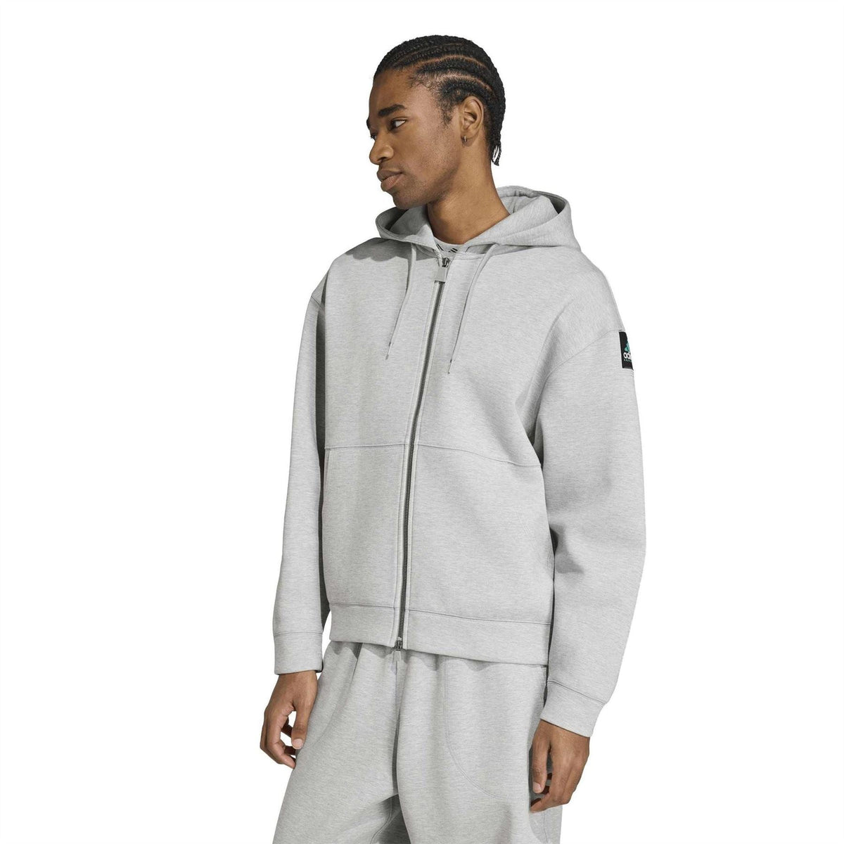 Grey heather zip-up hooded jacket worn by model, side view with ribbed cuffs