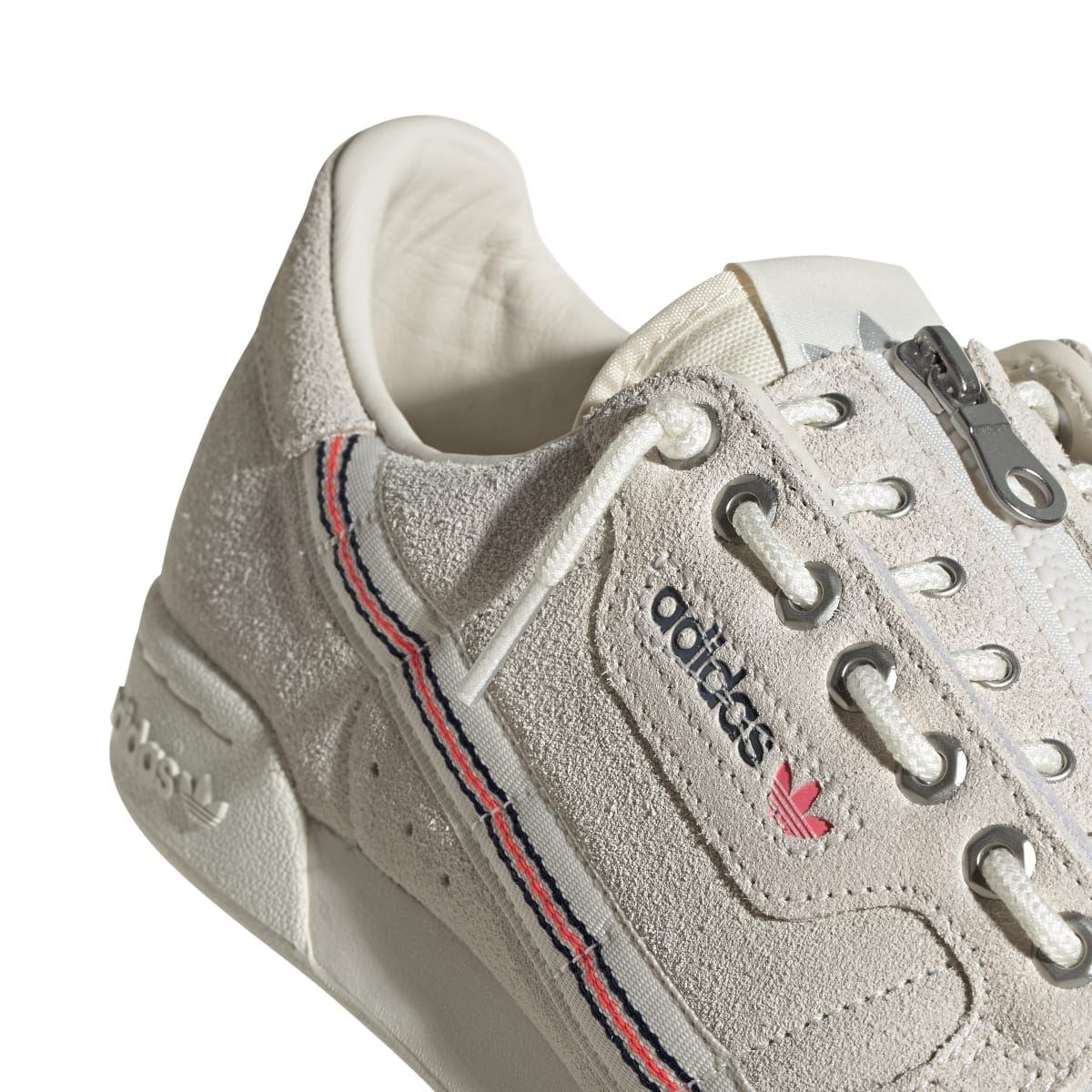 Close-up of light beige suede trainer upper with lace-up eyelets and adidas side logo