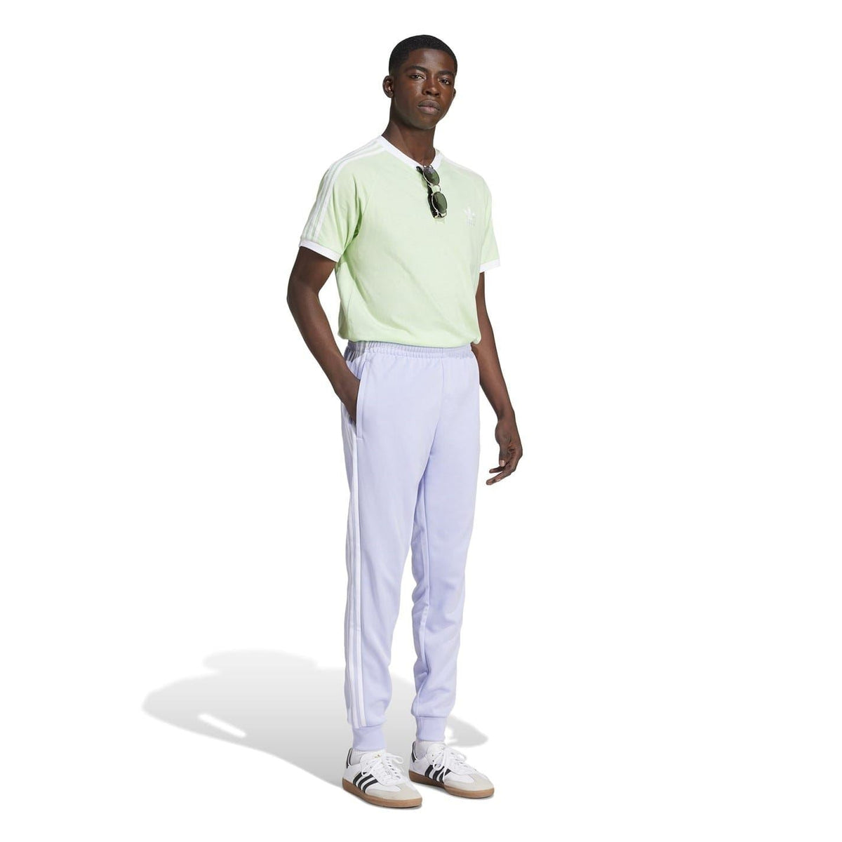 adidas Originals track pants in light purple, worn with a short-sleeve top