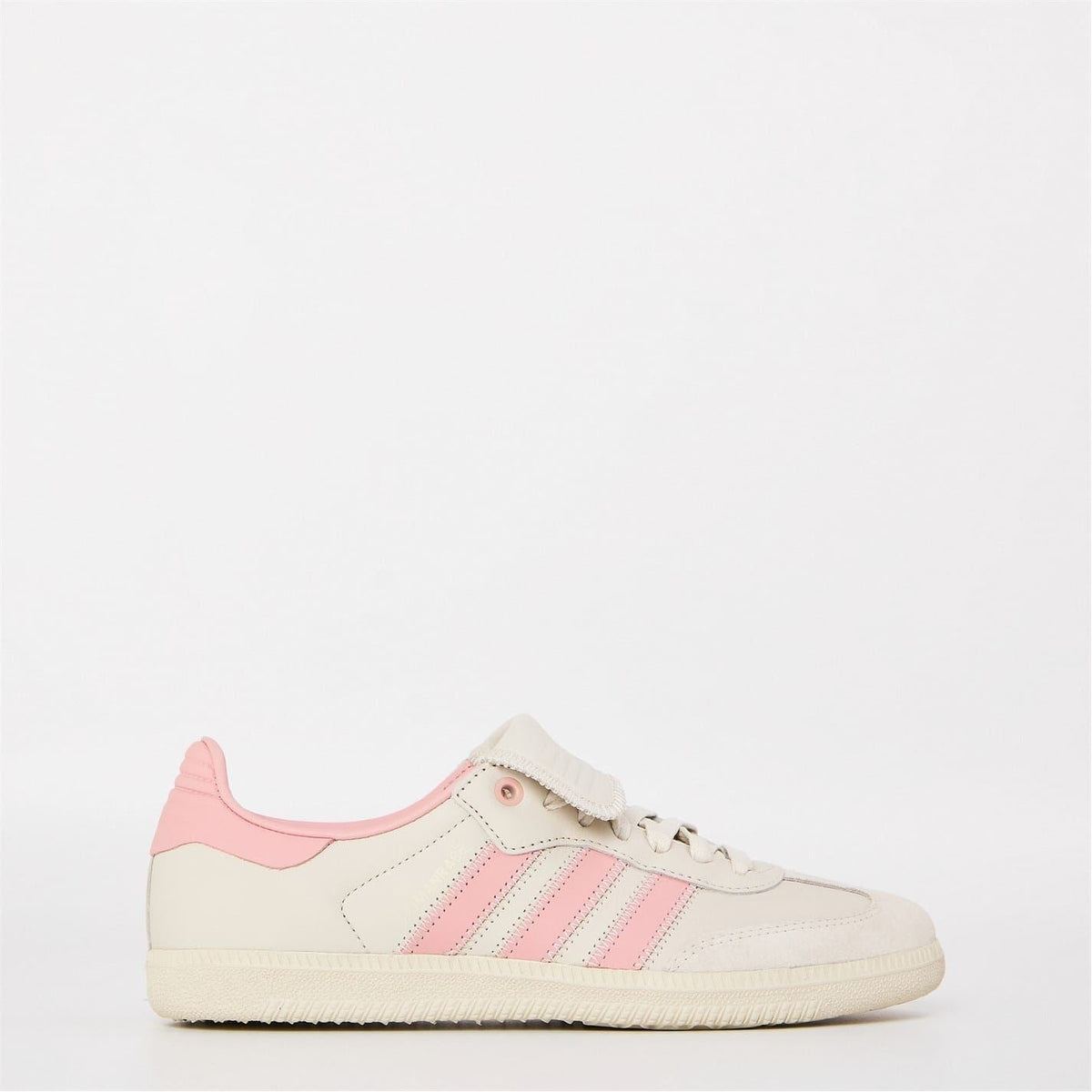 Low-top sneakers in off-white with pink three-stripe panels and lace-up front.
