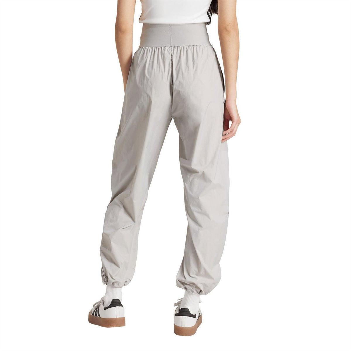 Light grey jogger pants with elastic waist and cuffed ankles, relaxed tapered fit