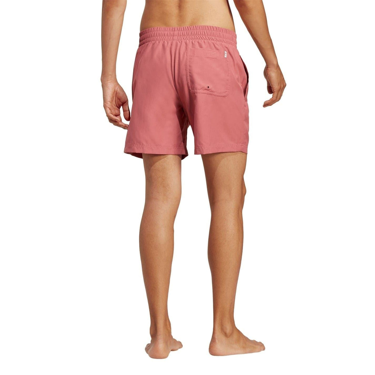 Pink adidas swim shorts from behind with back pocket detail and elastic waistband