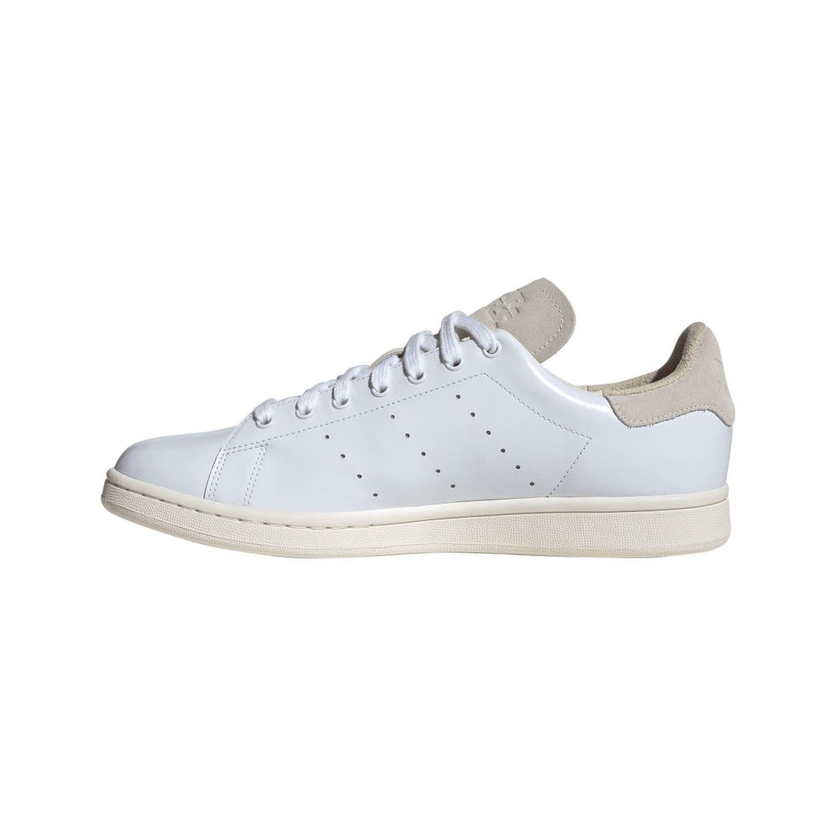 White lace-up trainers with beige suede collar and perforated toe; flat cupsole