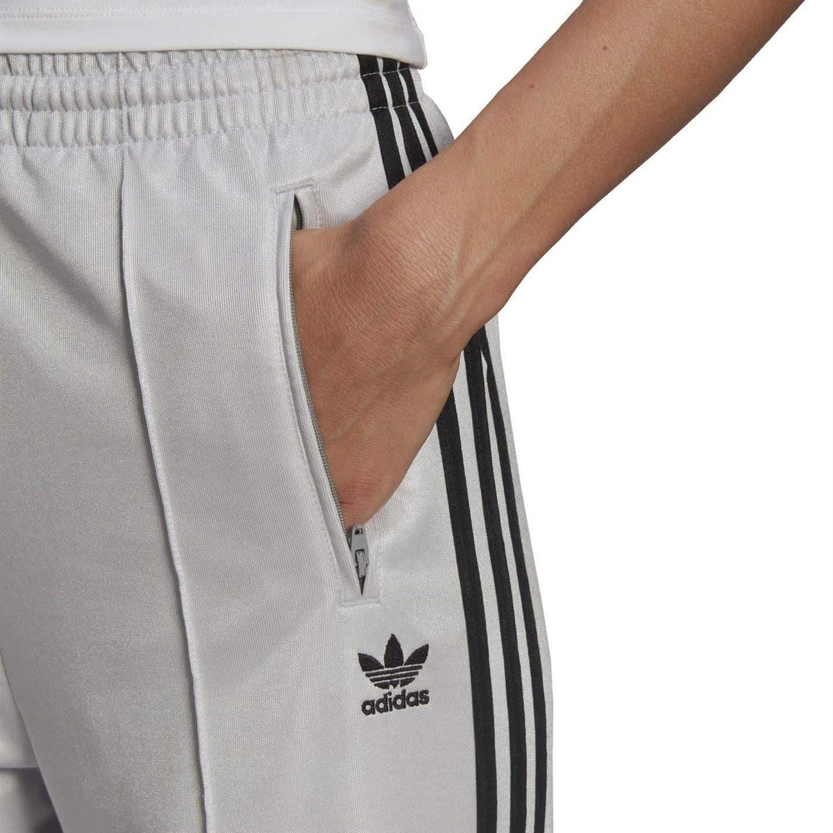 adidas logo patch on light gray sweatpants with black side stripe detail