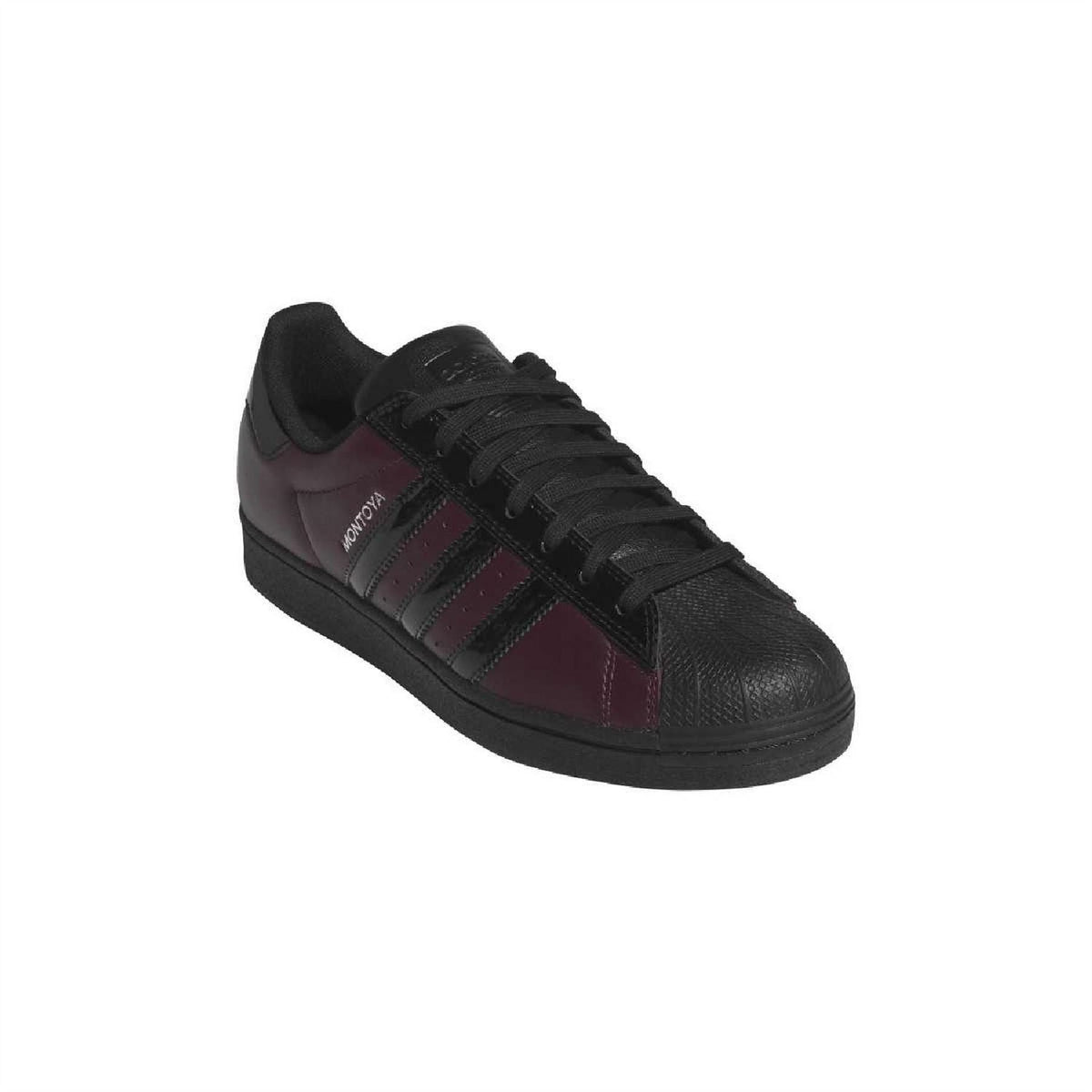 Maroon adidas sneakers with black laces, black stripes, and textured toe panel