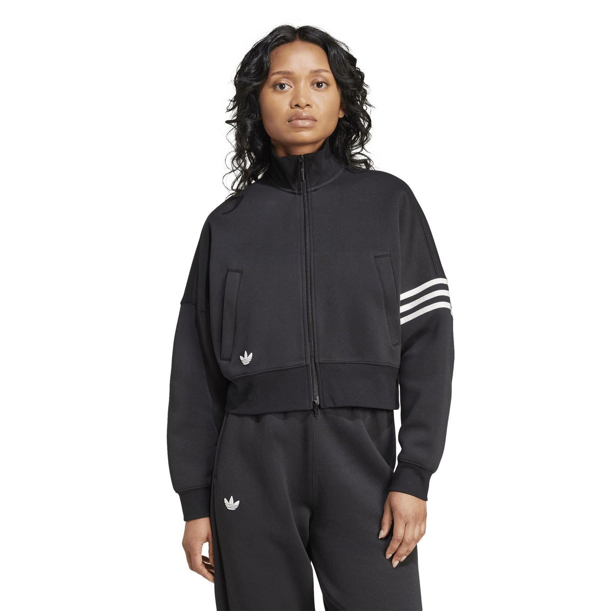 Black track top with full zipper, flap pockets, and contrast striped sleeves