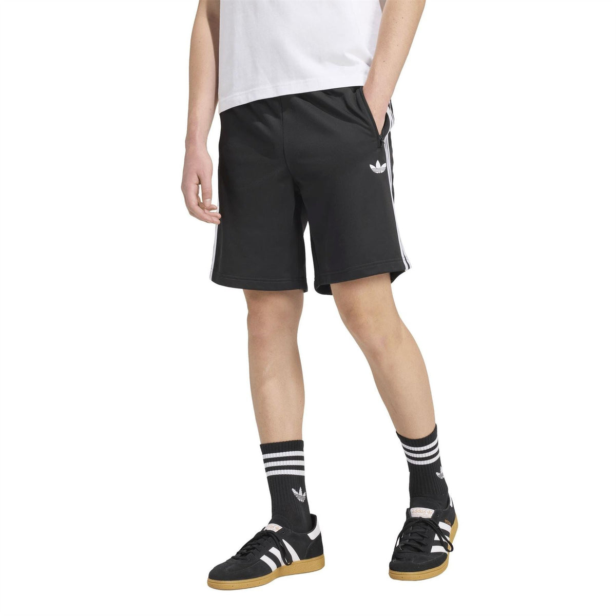 Black adidas track shorts with white triple side stripes and knee-length relaxed fit