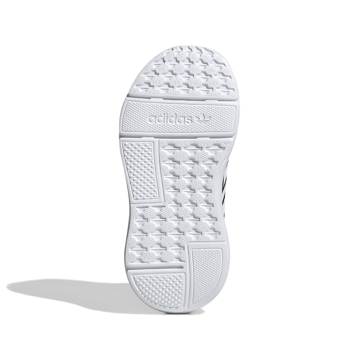 Infant sneaker outsole view: white textured tread with molded traction pattern