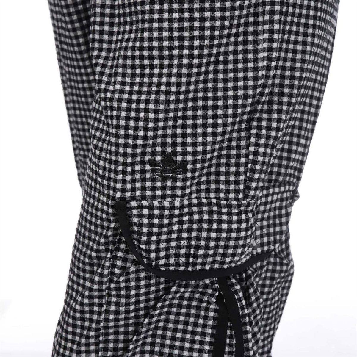Black-and-white check track pants with front drawstring and adjustable waist ties