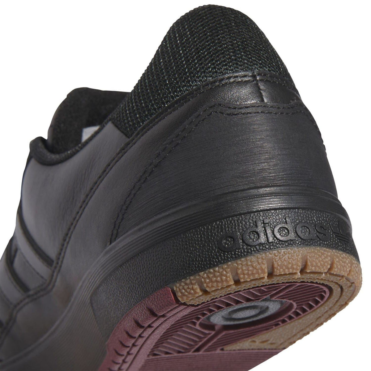 Black Tyshawn II heel with adidas logo and textured gum-style sole