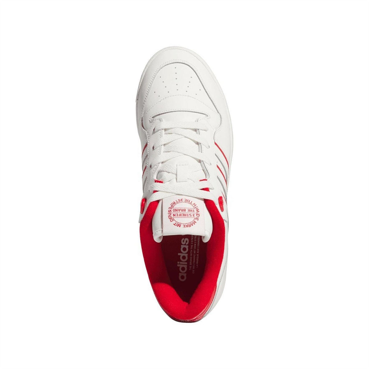 White low-top trainers with red interior lining visible through open collar.