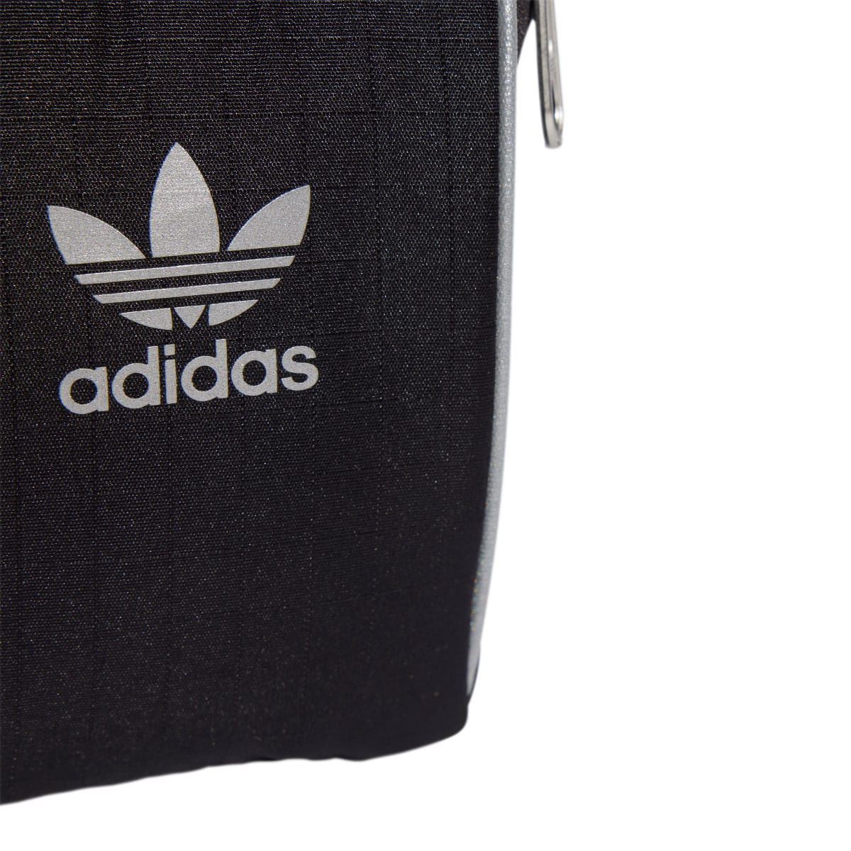 Black adidas small item bag with white adidas trefoil logo on front panel.