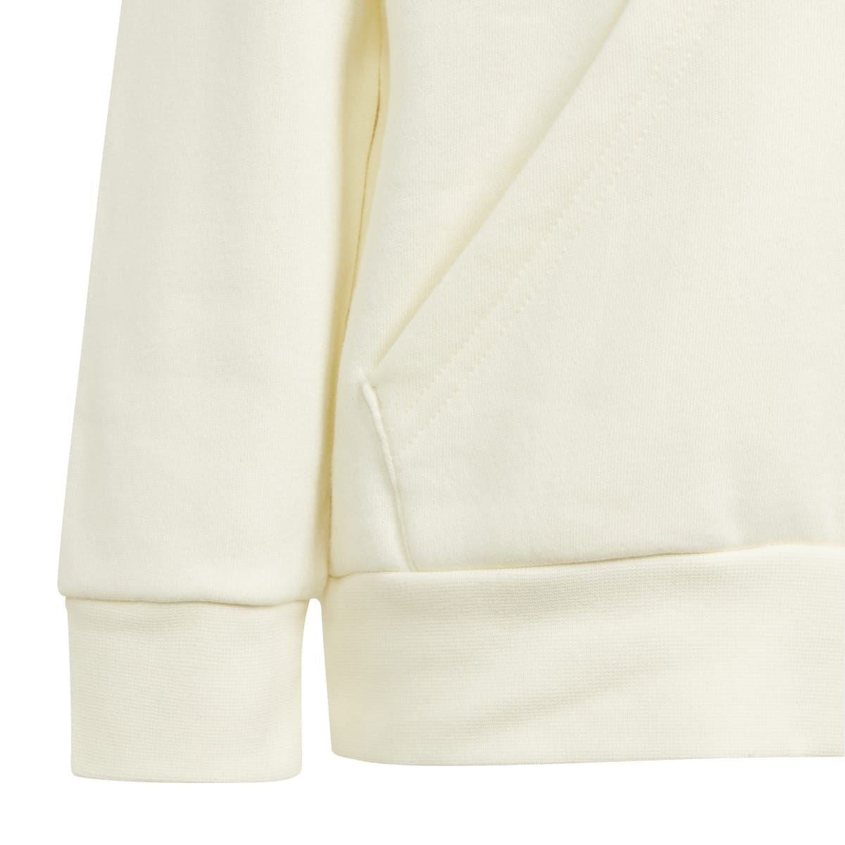 Kids' cream tracksuit fabric close-up: sleeve and hem cuff detail